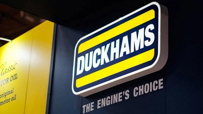 An illuminated Duckhams sign reading "The Engine's Choice" above a display of Classic motor oil.