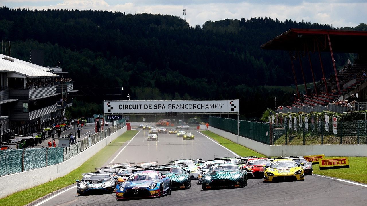 A grid of GT race cars lining up at Circuit de Spa-Francorchamps.