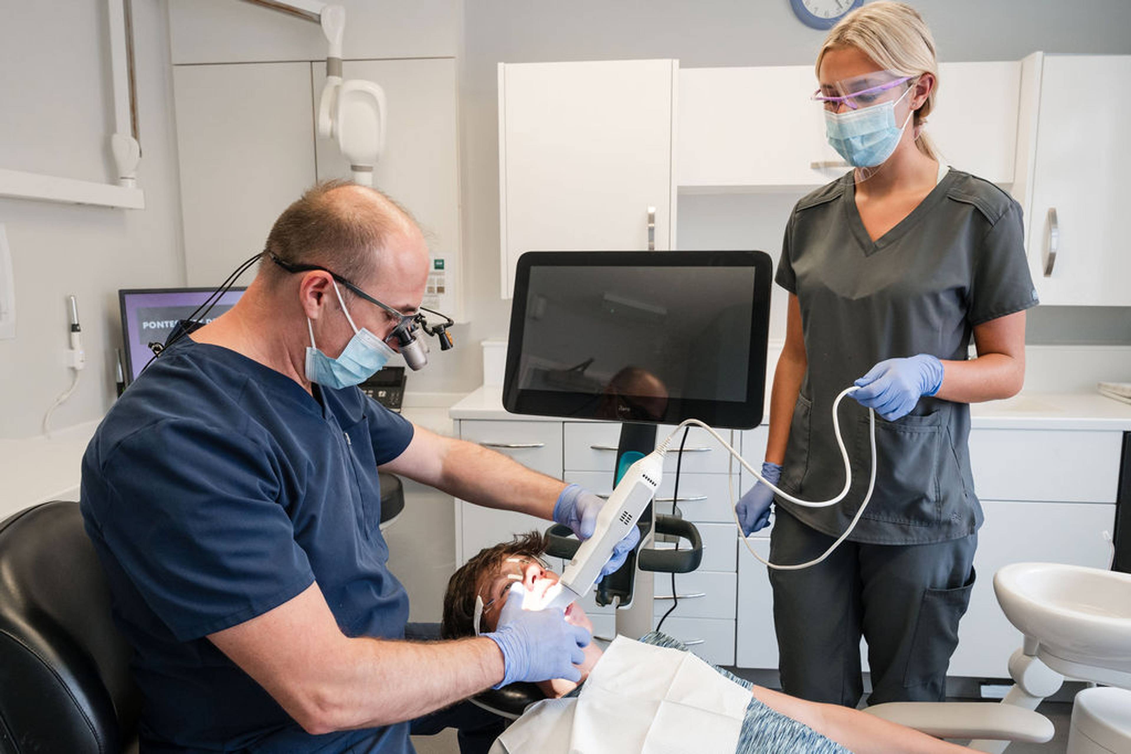Dental team using advanced intraoral scanning technology to capture detailed digital images during a general dentistry appointment.