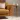 CGI render of a mustard sofa with brass effect side table in a living room setting