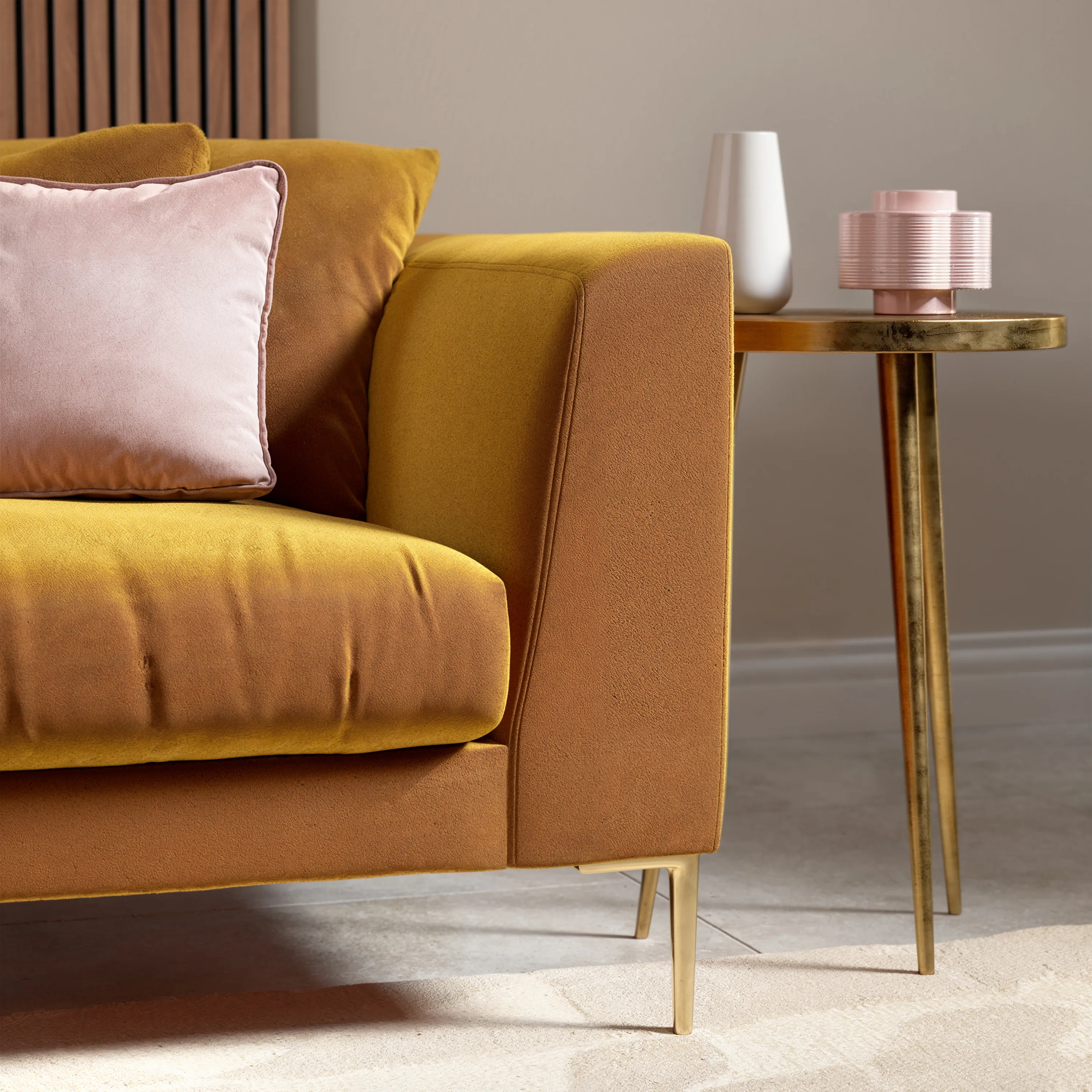 CGI render of a mustard sofa with brass effect side table in a living room setting