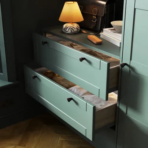 Forest green open Shaker-style drawer fronts make for a visually stunning and functional clothing storage solution.