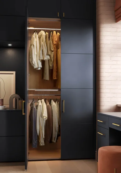 CGI wardrobe render showcasing a navy blue wardrobe with it's door open to reveal a beautifully designed cabinet interior with two clothing rails and oak timber finishes illuminated by overhead LED strips