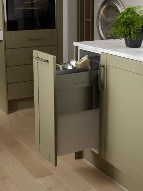 A green Shaker accessibility kitchen with pull-out eco-waste bin drawer CGI