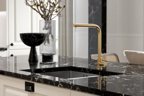 CGI image of a black granite worksurface with a gold kitchen tap