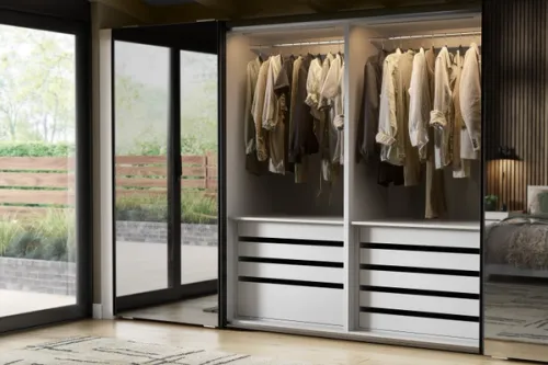 Mirrored sliding door wardrobe, open displaying illuminated clothing rail and internal drawers