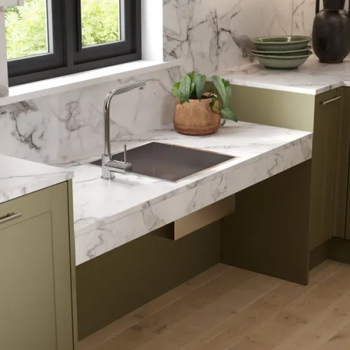 CGI render of an adjustable height sink area in a green Shaker style accessibility kitchen