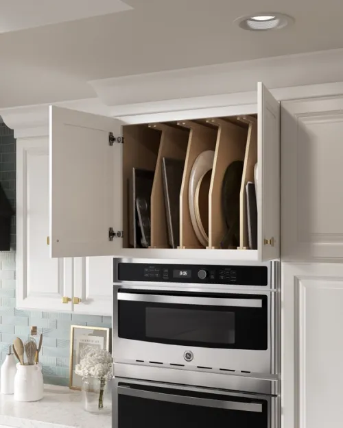 3D render showing internal storage tray dividers in a tall oven housing.