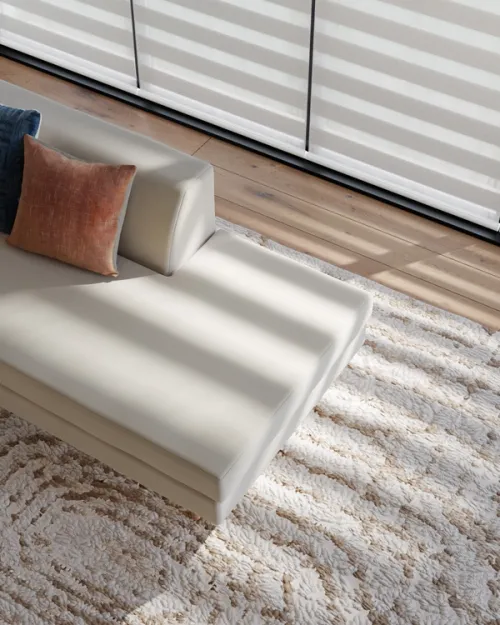 CGI lifestyle image of shadows on a sofa from a dual shade window blind.