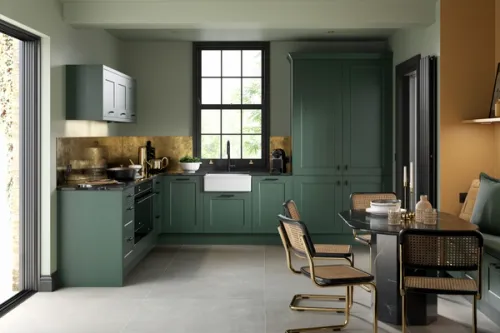 CG image of a contemporary dark green shaker kitchen with brass accessories and patinated brass splashback