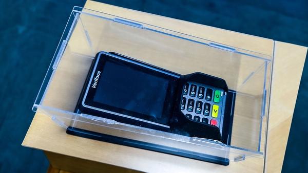 The last outdated payment terminal, encased in glass, marking the completion of a project to replace 2,585 terminals across 680 stores.