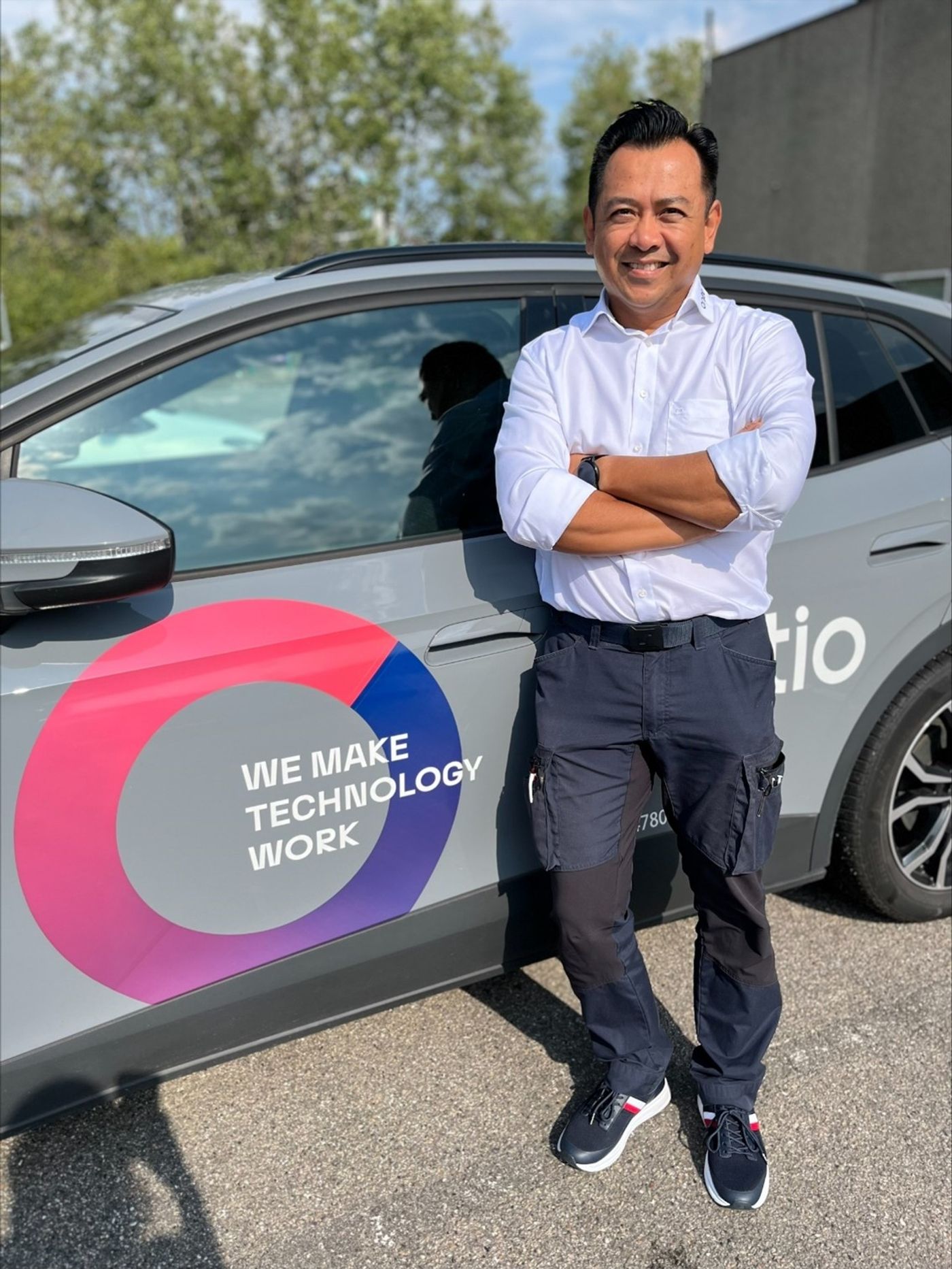 Portrait of dedicated employee with car