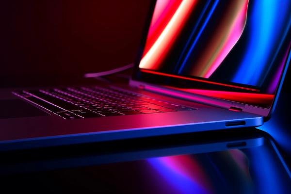 a close up of a laptop computer with colorful lights on it .
