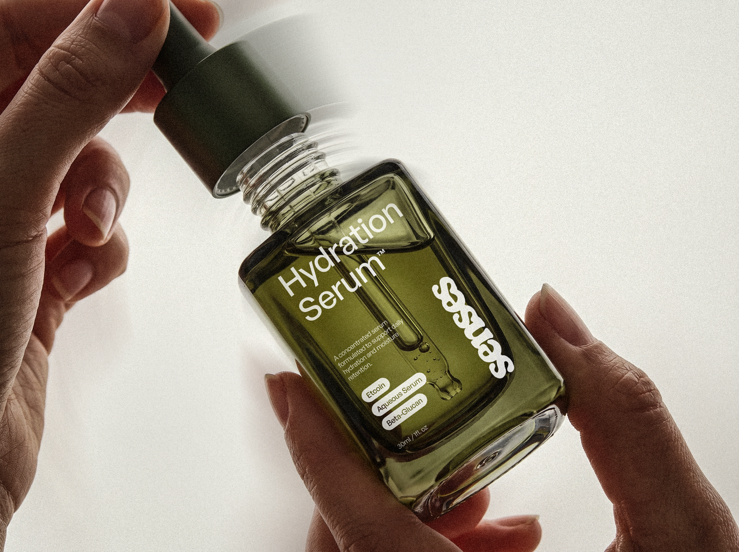SENSES Hydration Serum bottle held between two hands