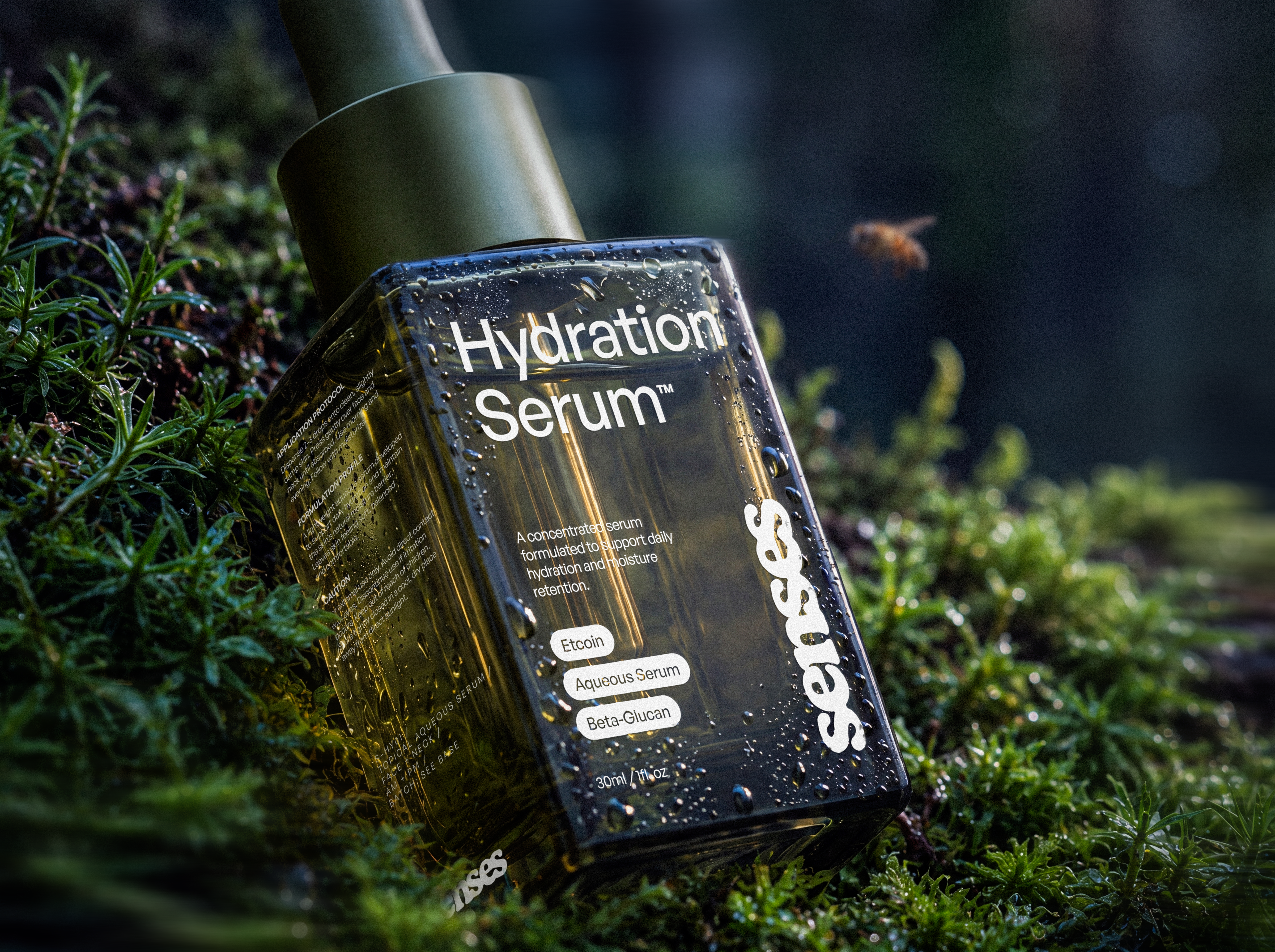 SENSES Hydration Serum bottle resting in wet moss