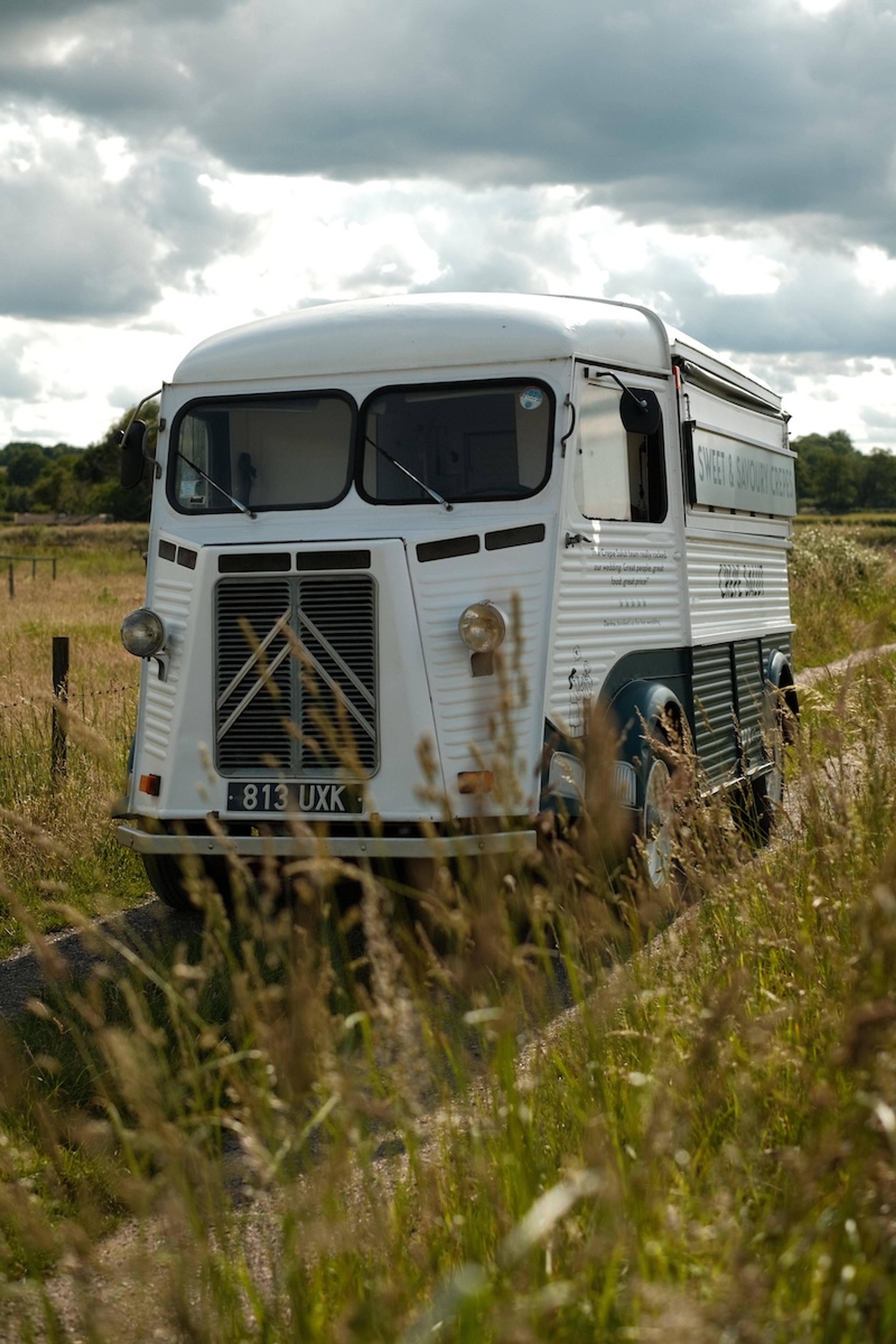The vintage Citroën van parked on a grassy track