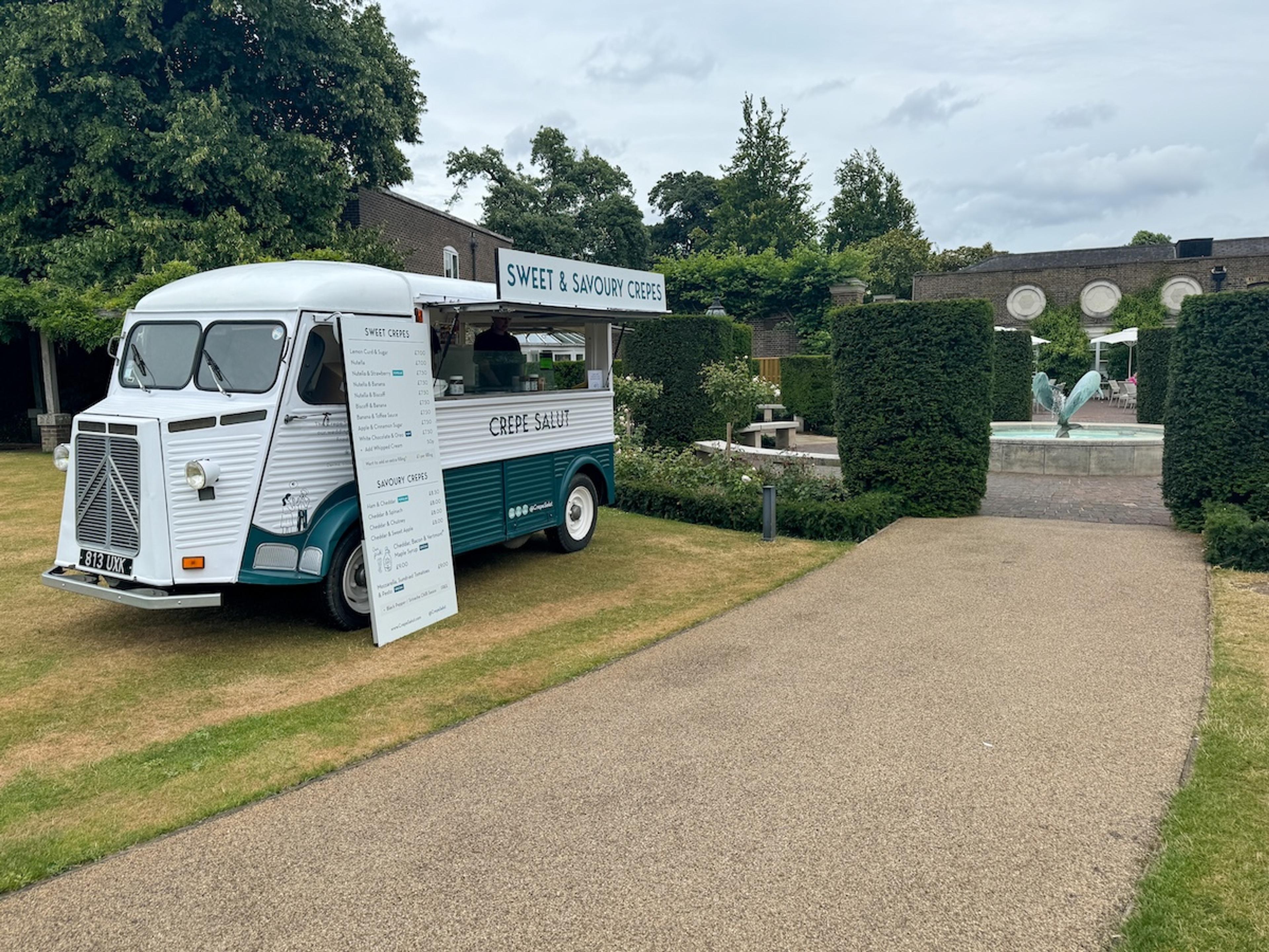 The crepe van beside a gravel path in a formal garden