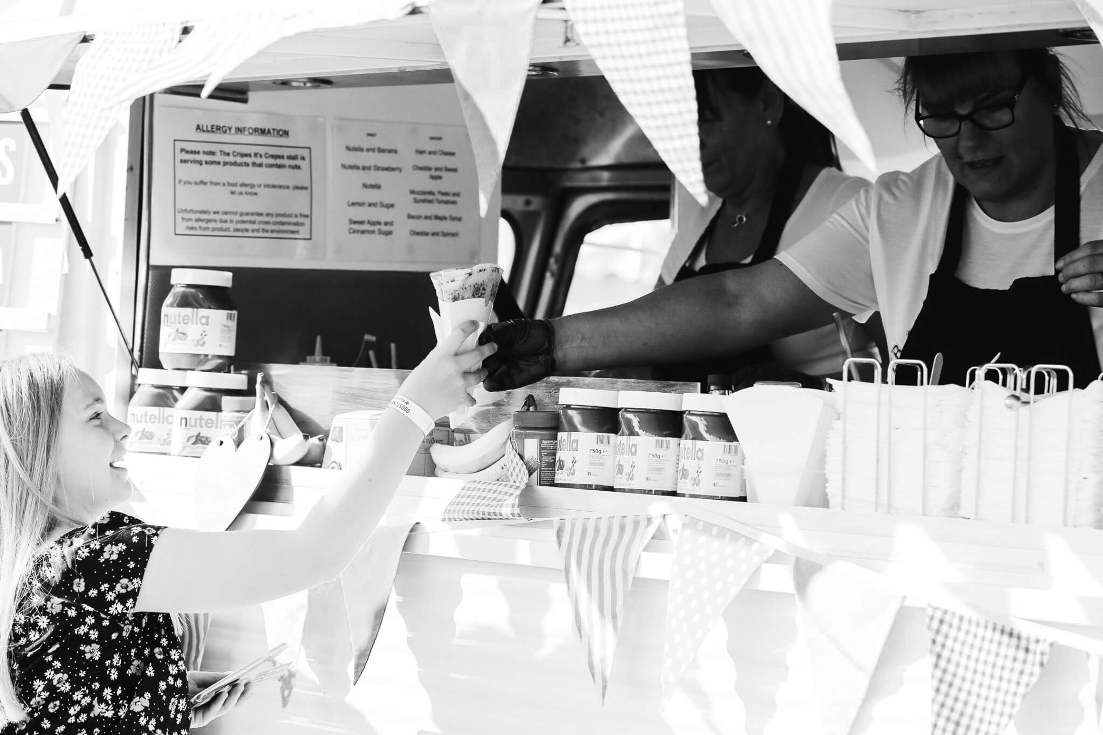 A child being served at the van hatch