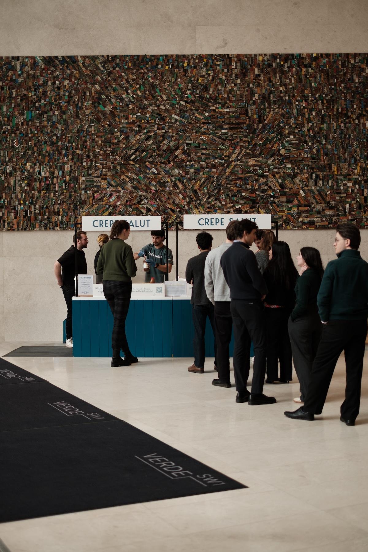 A queue at the Crepe Salut counter in an office lobby