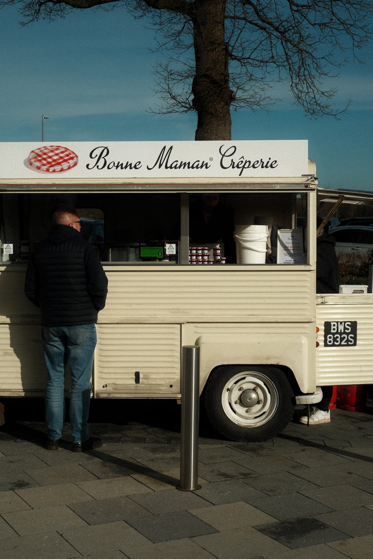 A customer at the white-label Bonne Maman Creperie van