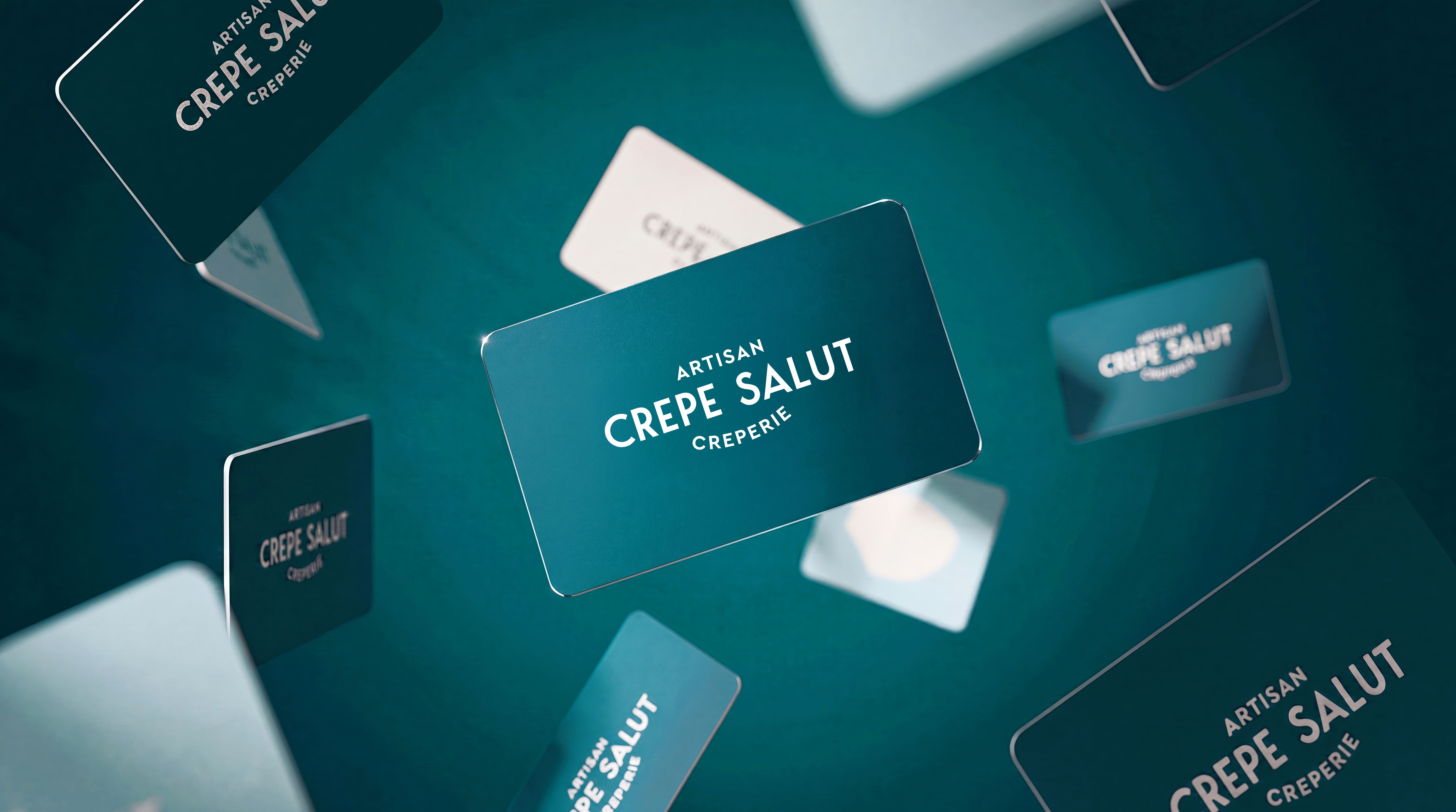 Crepe Salut loyalty cards floating on a teal background
