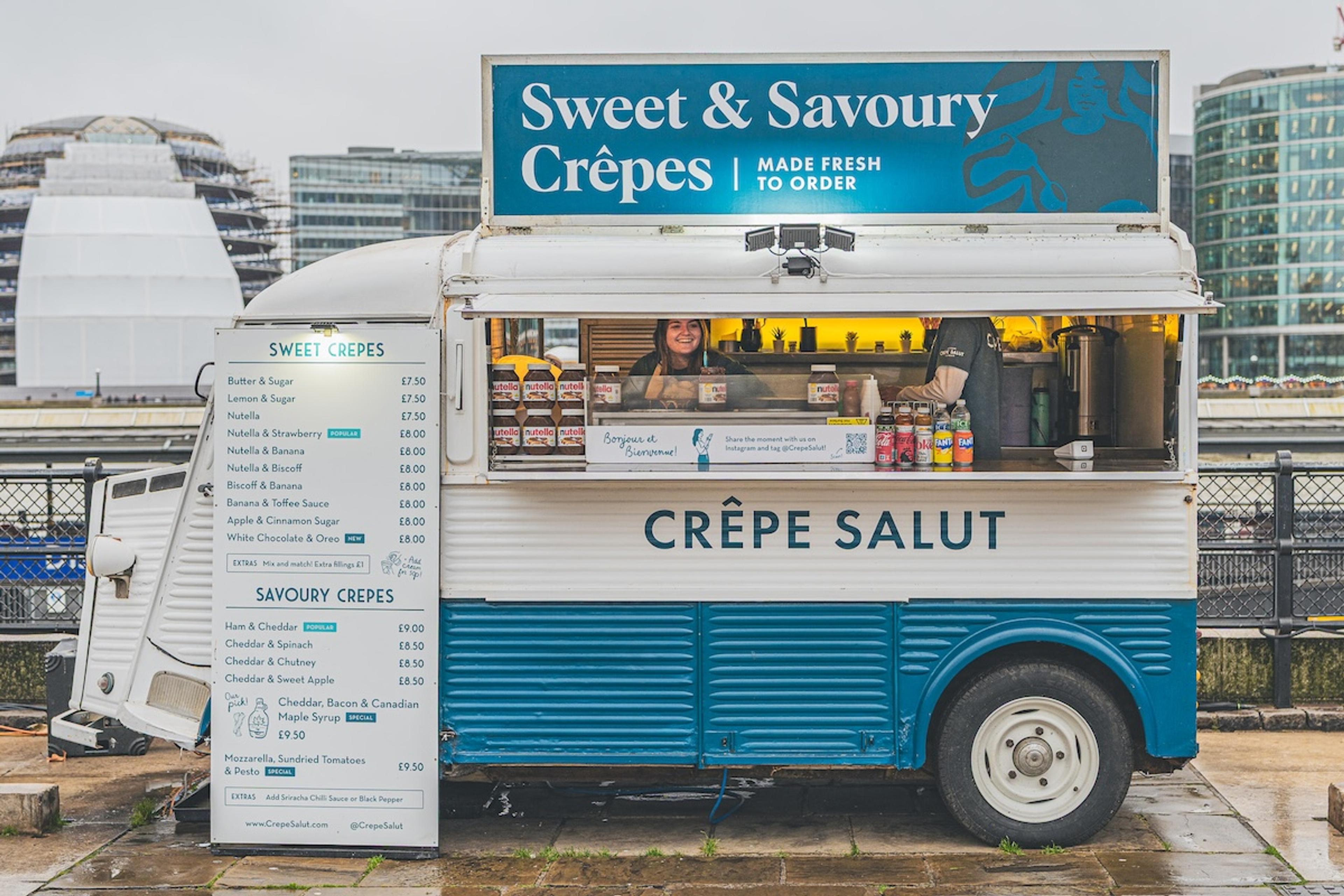The crepe van on the riverside with its menu board