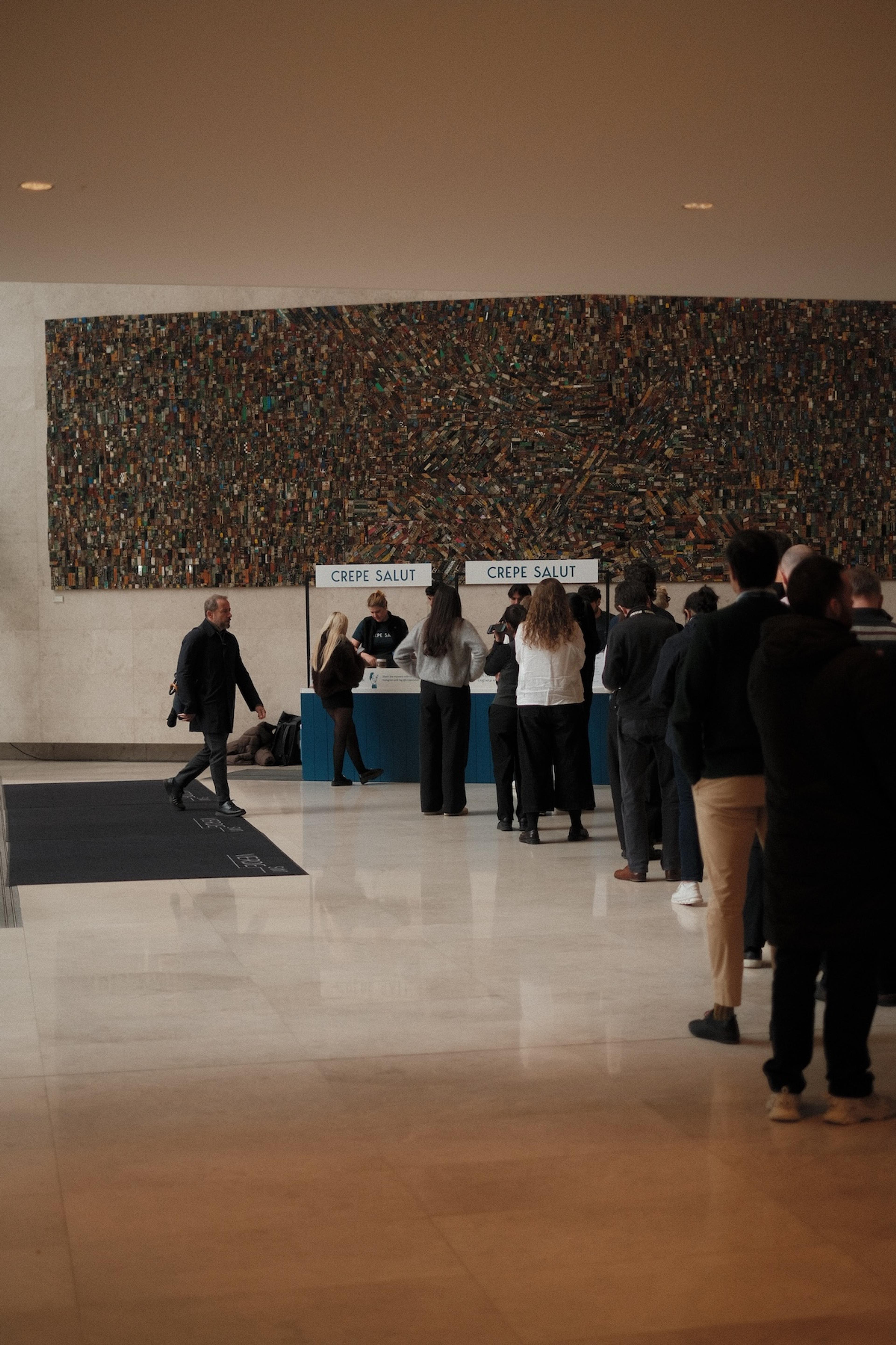 A queue at the Crepe Salut counter in a large lobby