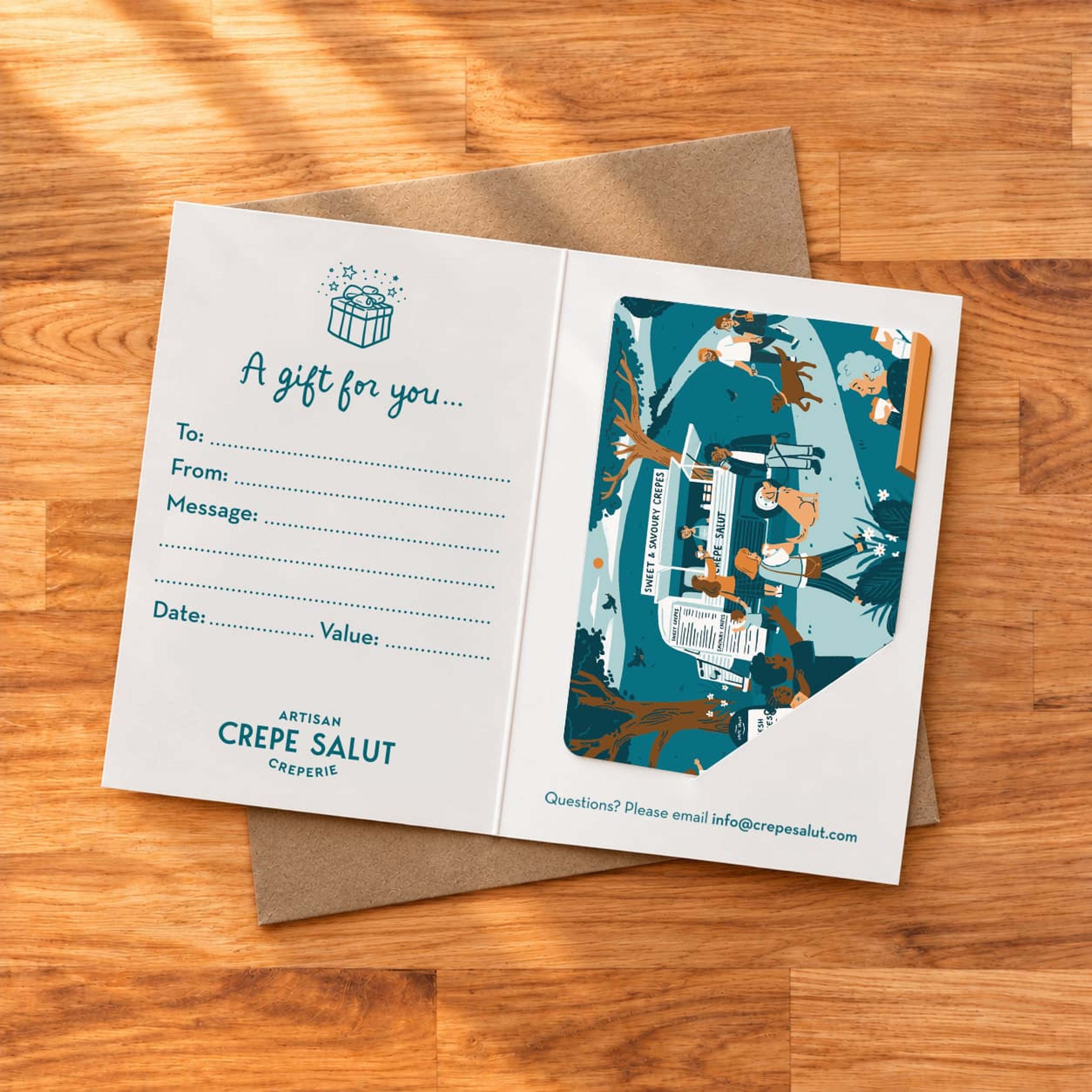 A Crepe Salut gift card in its printed greetings sleeve
