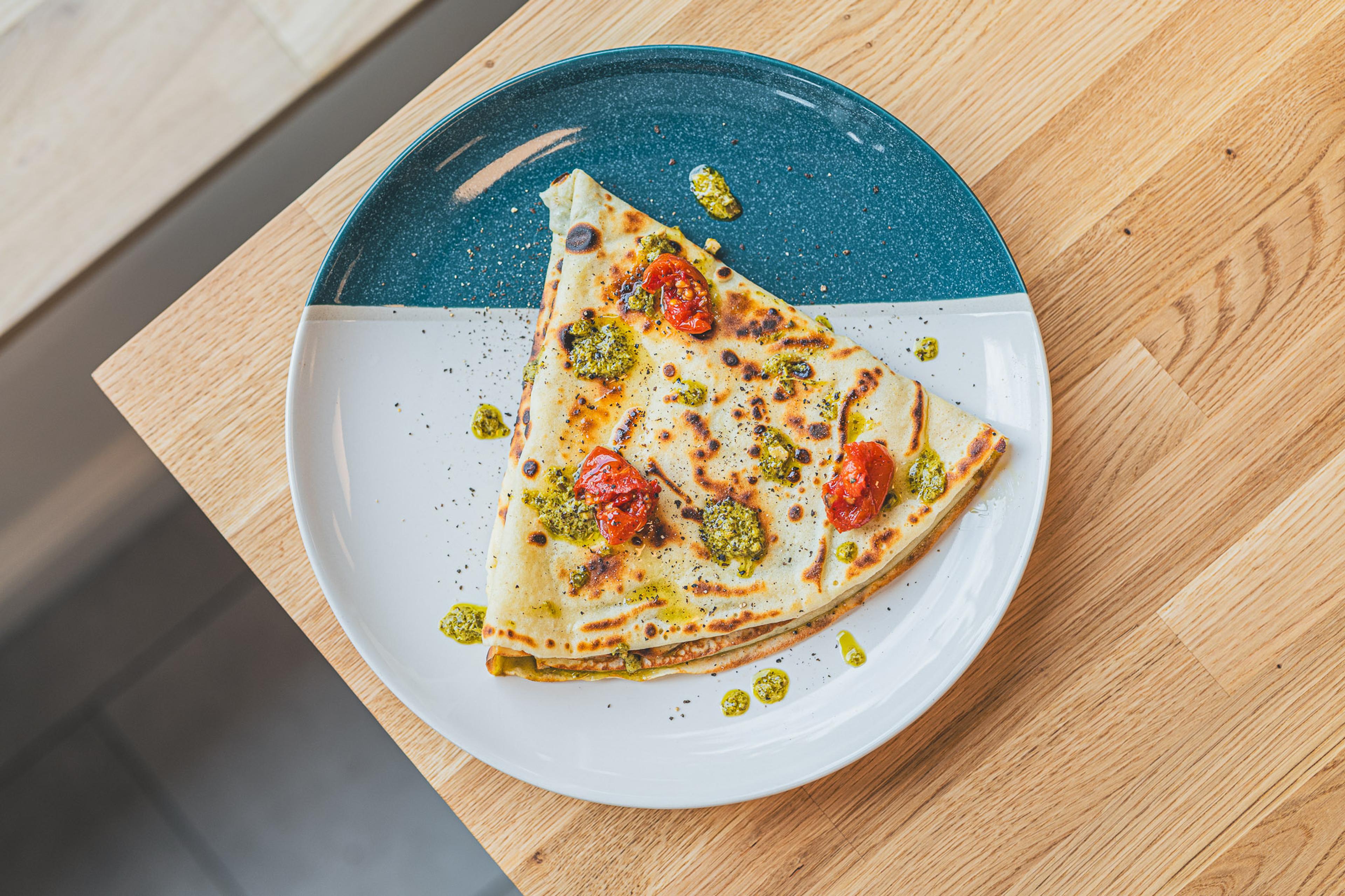A pesto and tomato crepe, seen from above