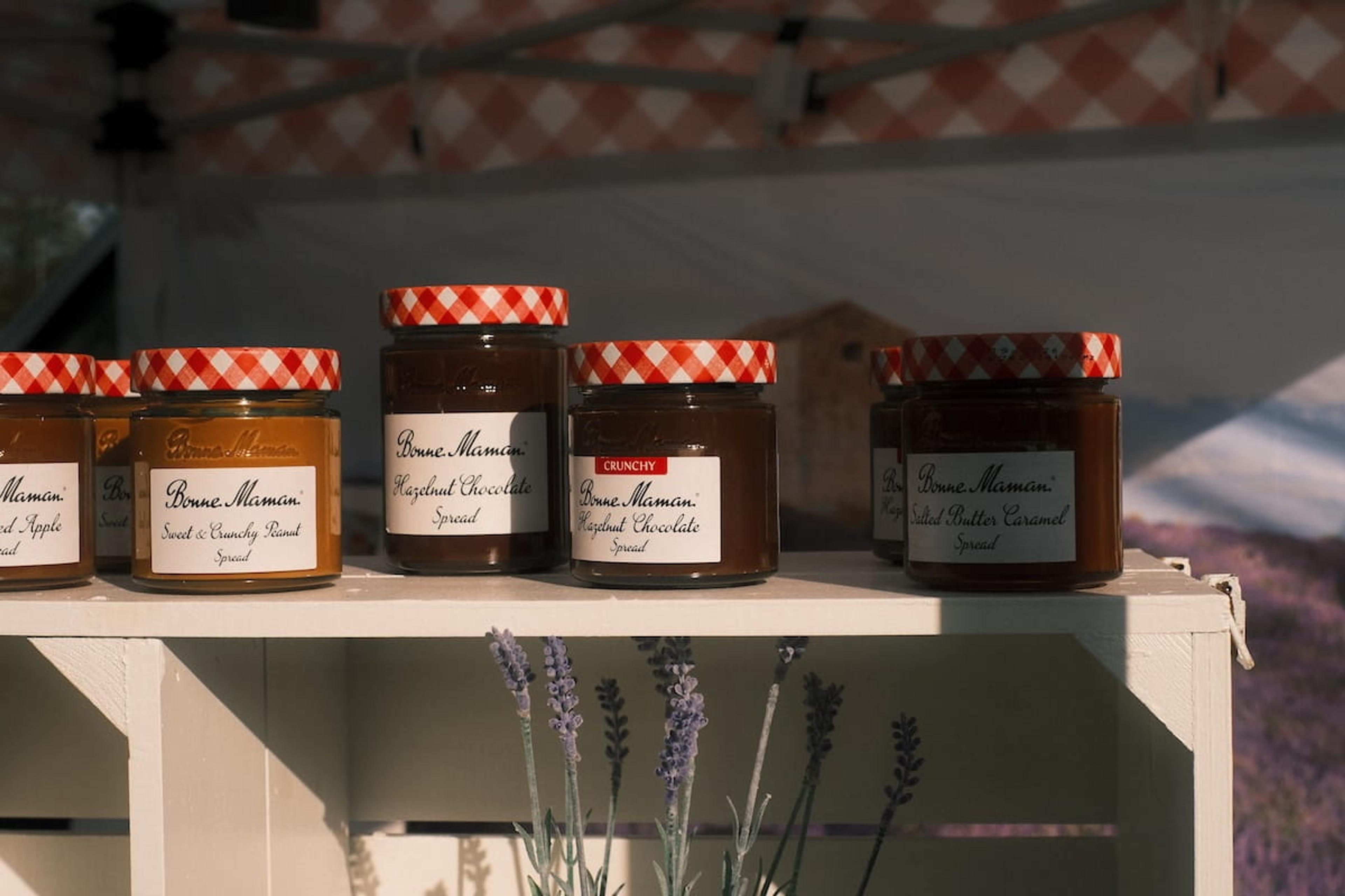Jars of Bonne Maman sweet spreads lined up on the sampling stand