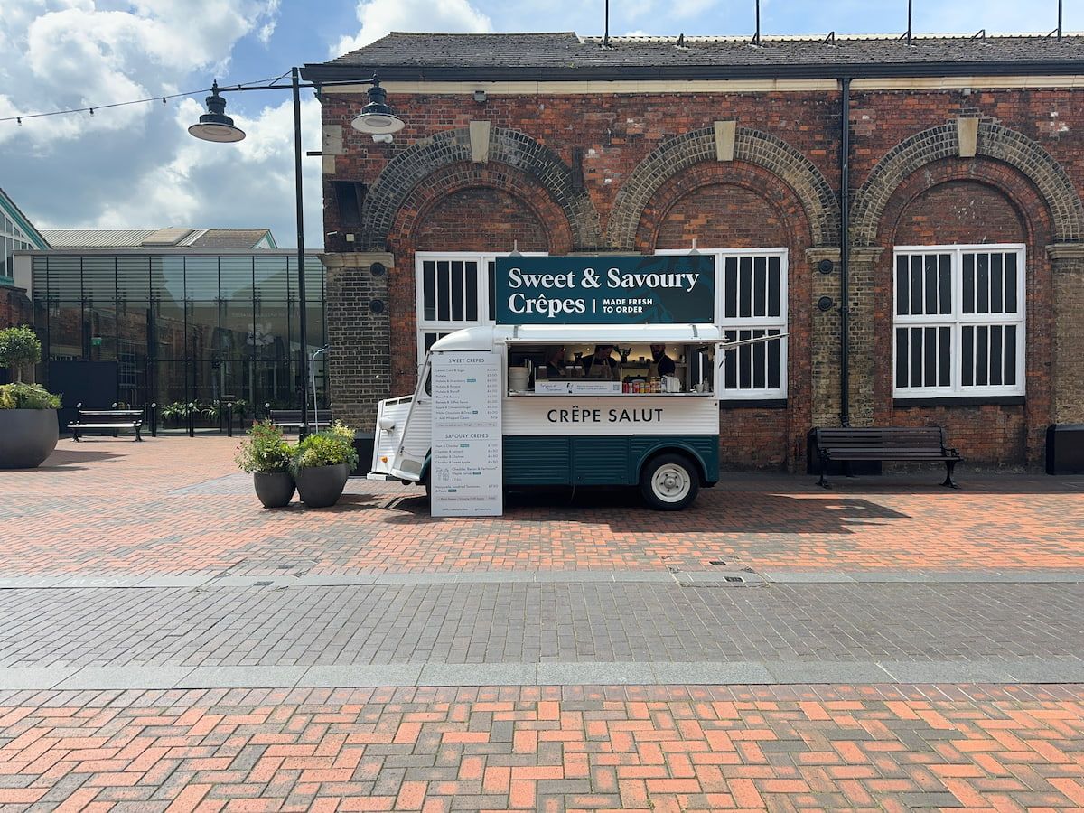 The crepe van outside a brick warehouse
