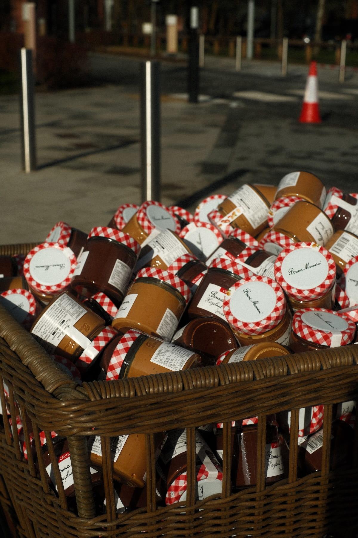A wicker basket filled with jars of Bonne Maman spreads