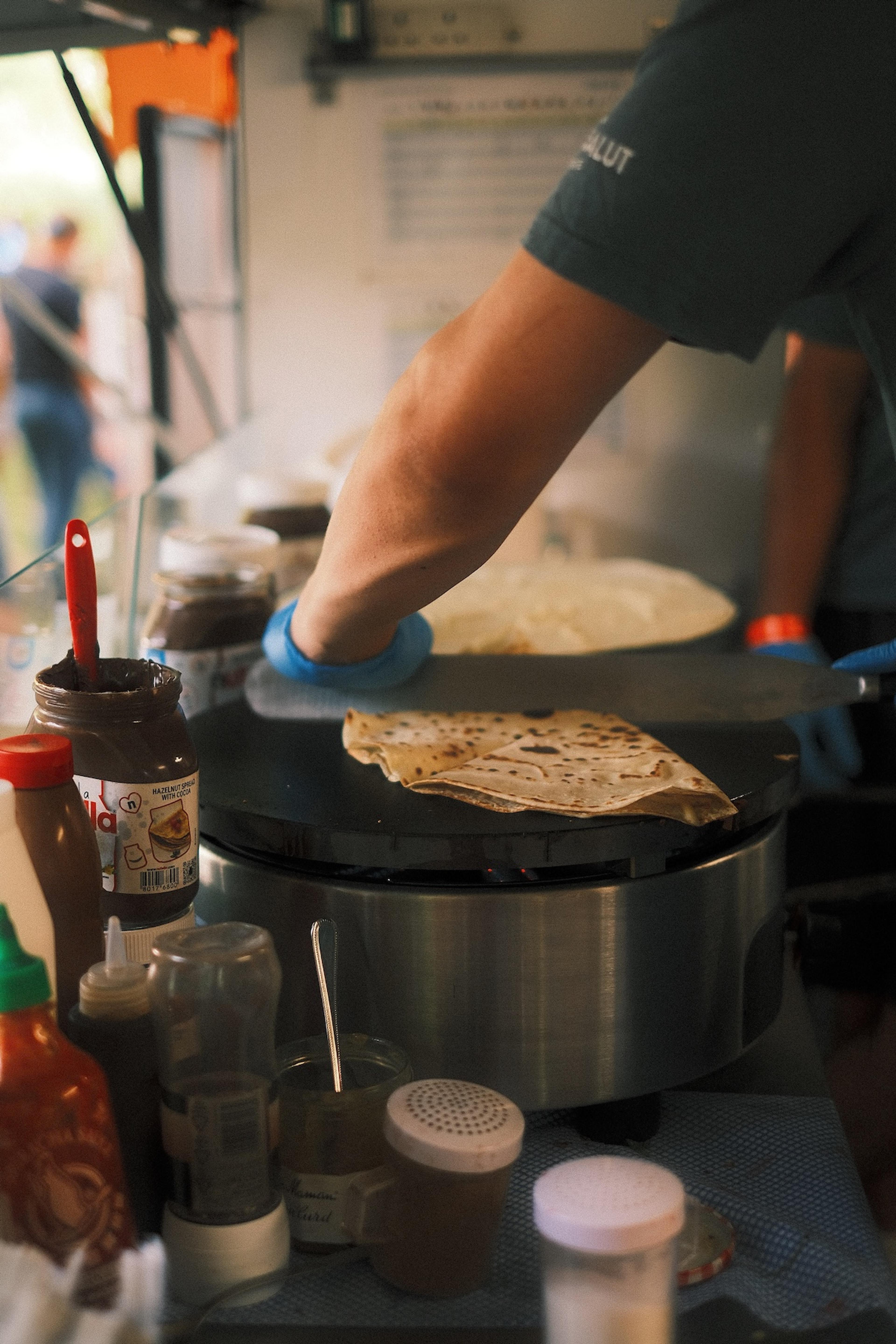 Folding a crepe on the griddle in the van