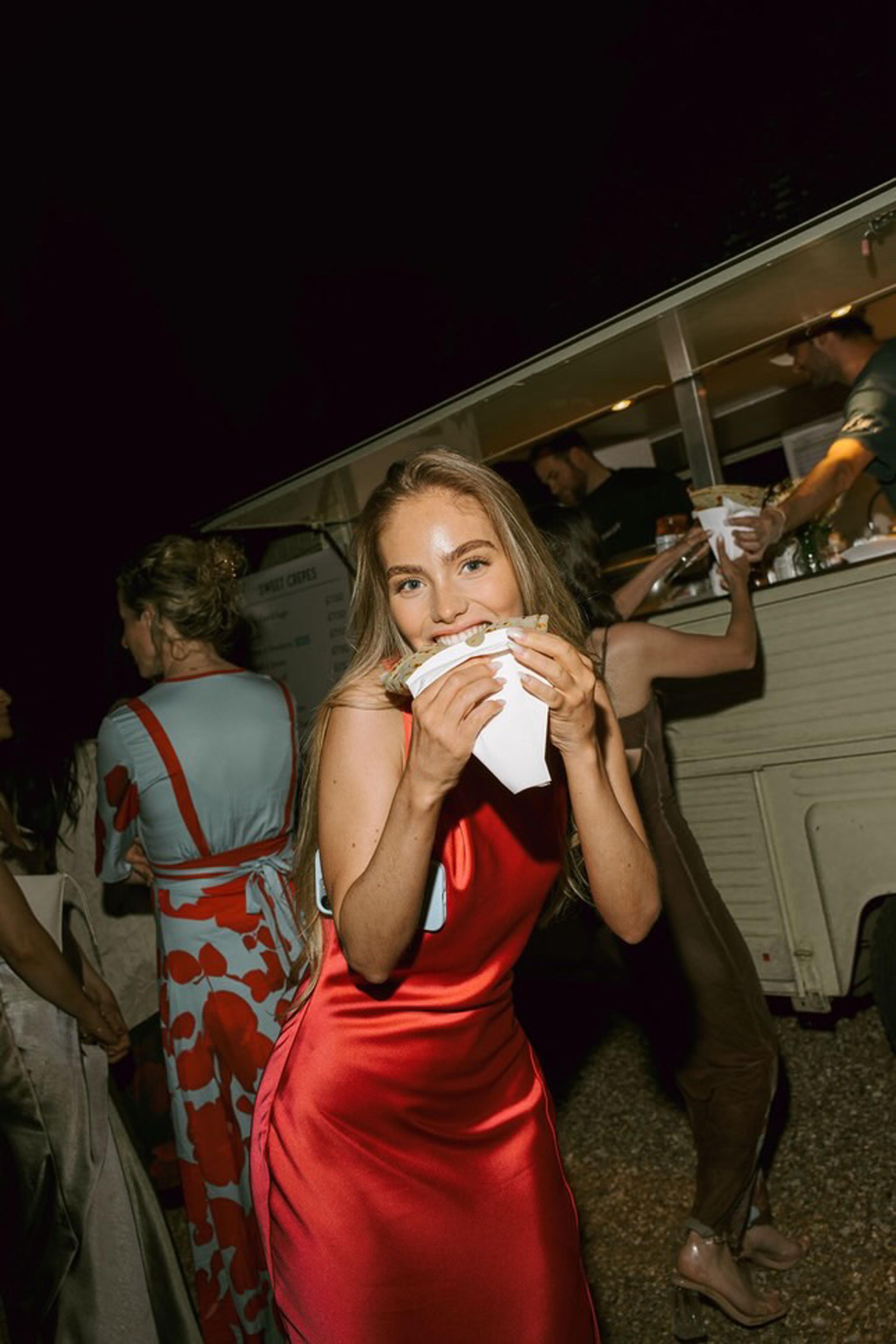 A party guest enjoying a crepe at night