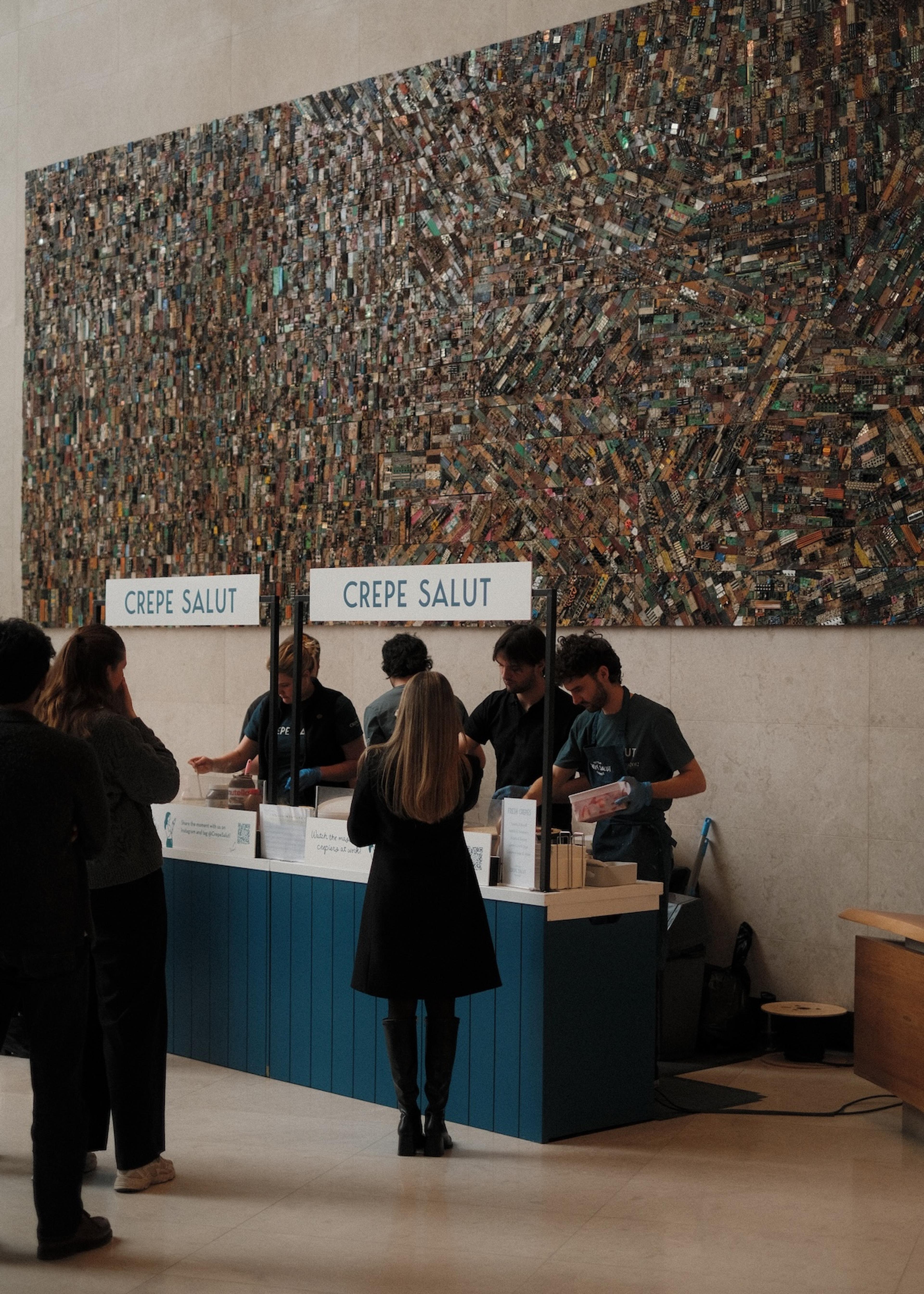 A Crepe Salut counter serving guests in an office lobby