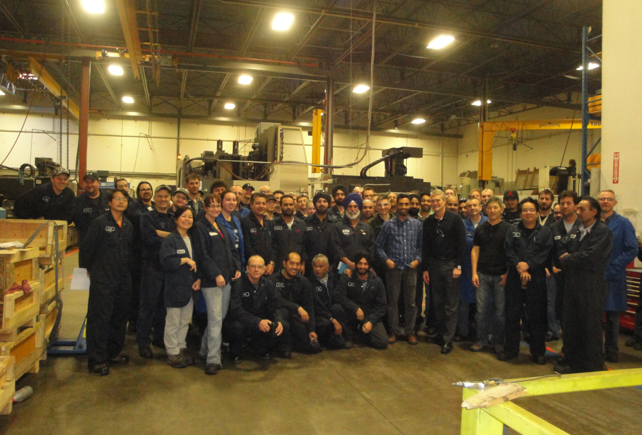 SICOM shop floor team gathered among the machining centres for a group photo