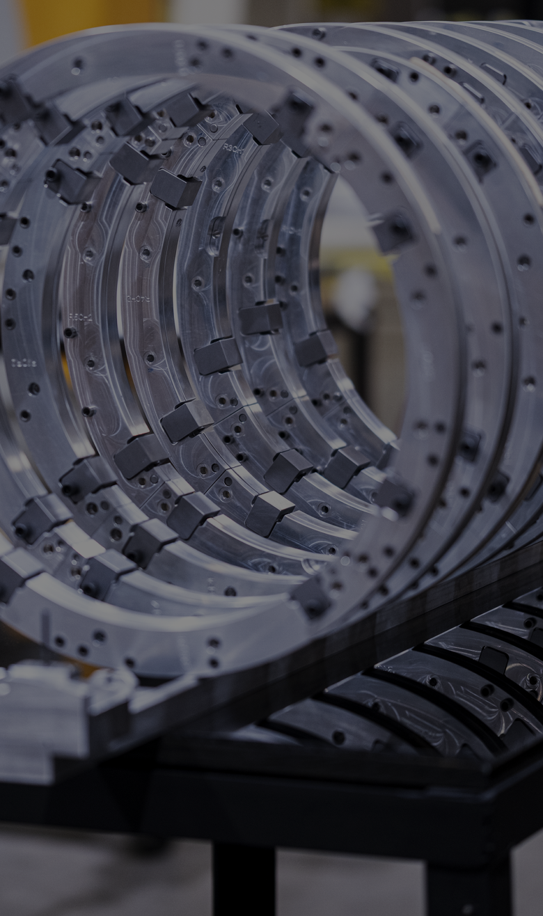 Nested machined ring segments with bolt holes and mounting blocks