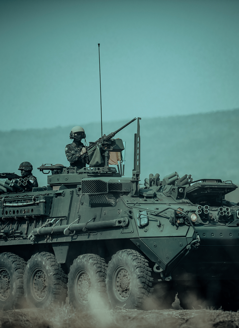 Crew member manning the turret of a Stryker armoured fighting vehicle