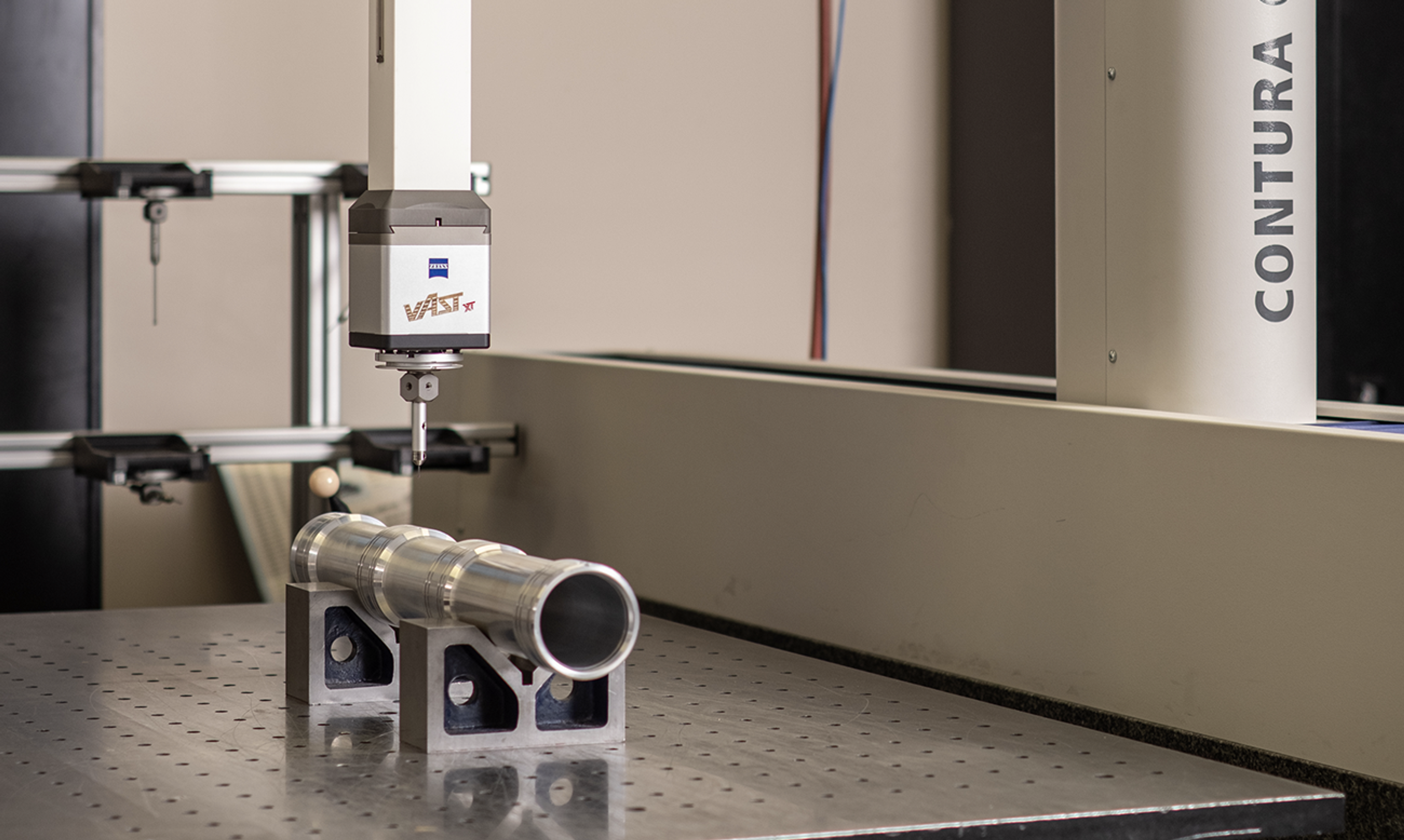 Zeiss CONTURA coordinate measuring machine probing a machined cylindrical part