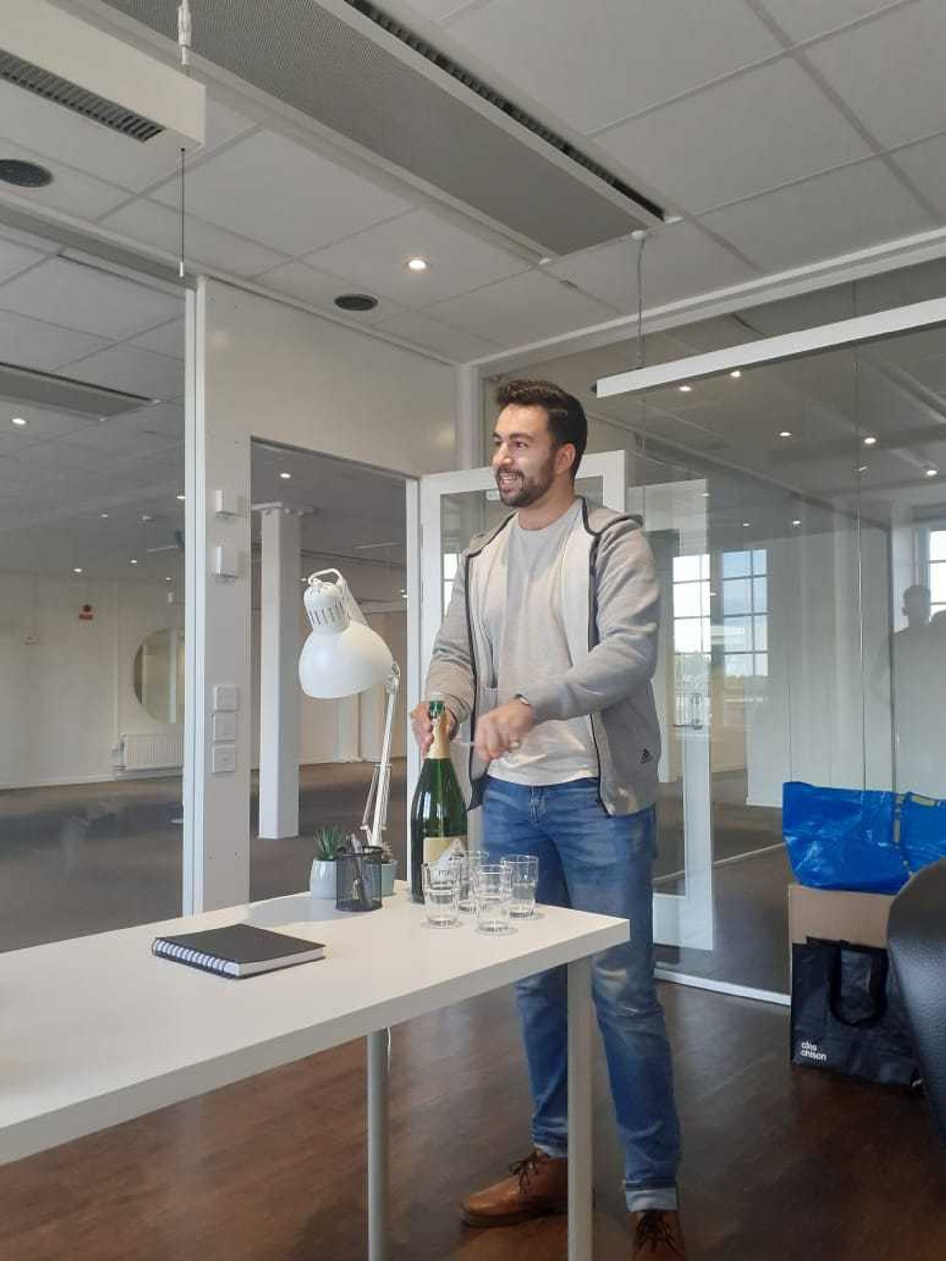 hamza opens champagne in the new ecobloom office