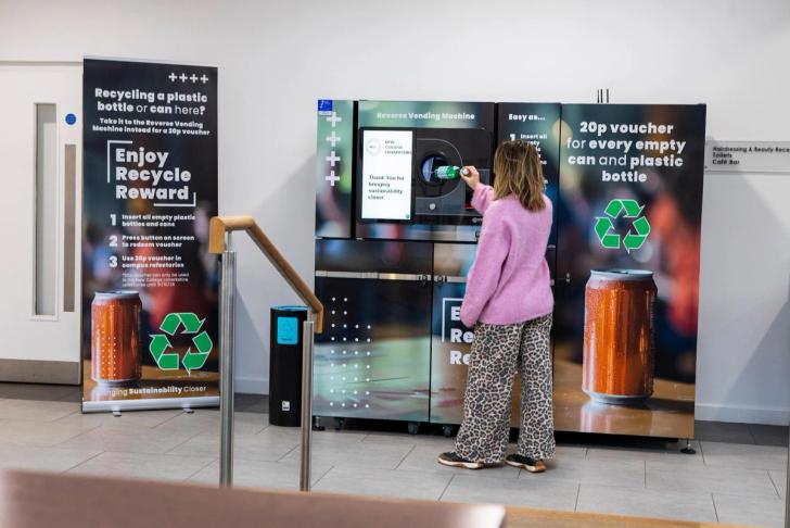 Student putting a bottle in the reverse vending machine