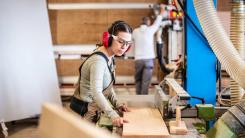 Woman wearing protective goggles in a workshop