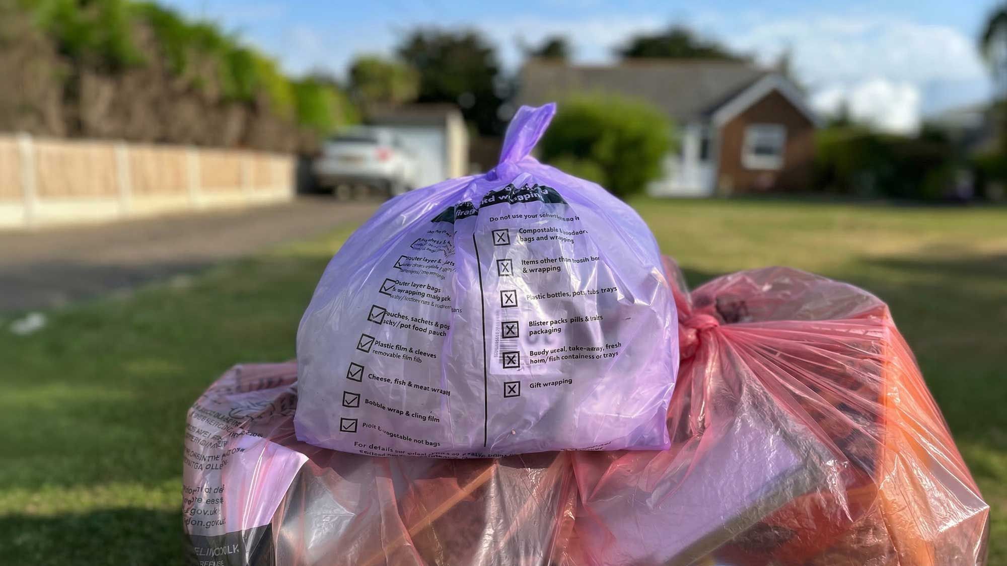 A plastic bag containing plastic film, presented for collection outside a residential house as part of the FlexCollect trial