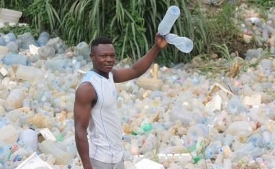 Boy holding plastic bottle in Cameroon