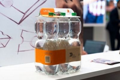 Multipack of plastic with cardboard and paper replacing plastic wrapping to hold bottles together