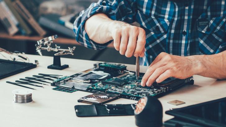 Close-up of somebody repairing a motherboard