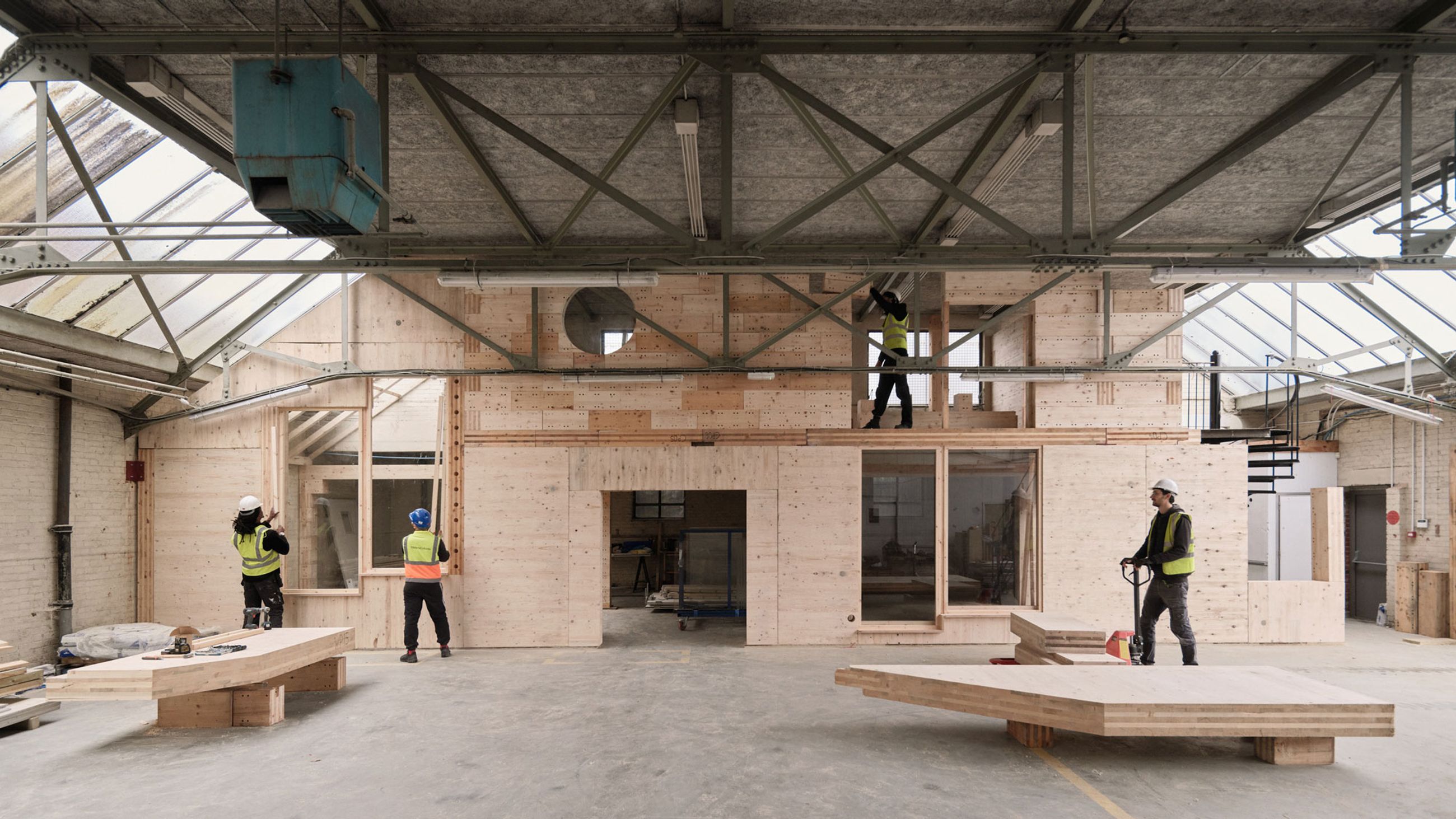 Circular Construction Hub workers refurbishing a building in hi-vis jackets