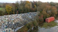 Environment Agency investigation secures arrests for environmental and money laundering offences linked to 21,000-tonne site.