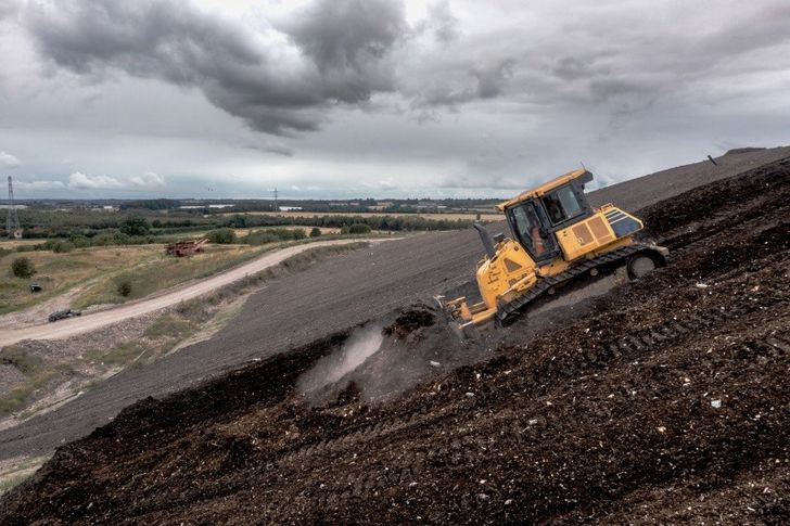Bulldozer on slope of an inert landfill
