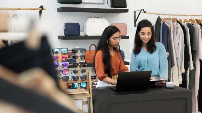 Two people at the till of a clothes shop